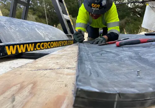 A technician performing conveyor belt repair in Florida