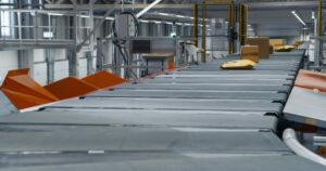Various Sized Brown Cardboard Packages Move Along a conveyor belt, which was fixed from Conveyor Belt Repair in St. Petersburg FL